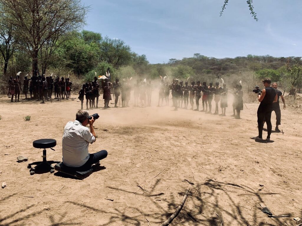 Mario Testino outdoors photographing a subject for A Beautiful World series